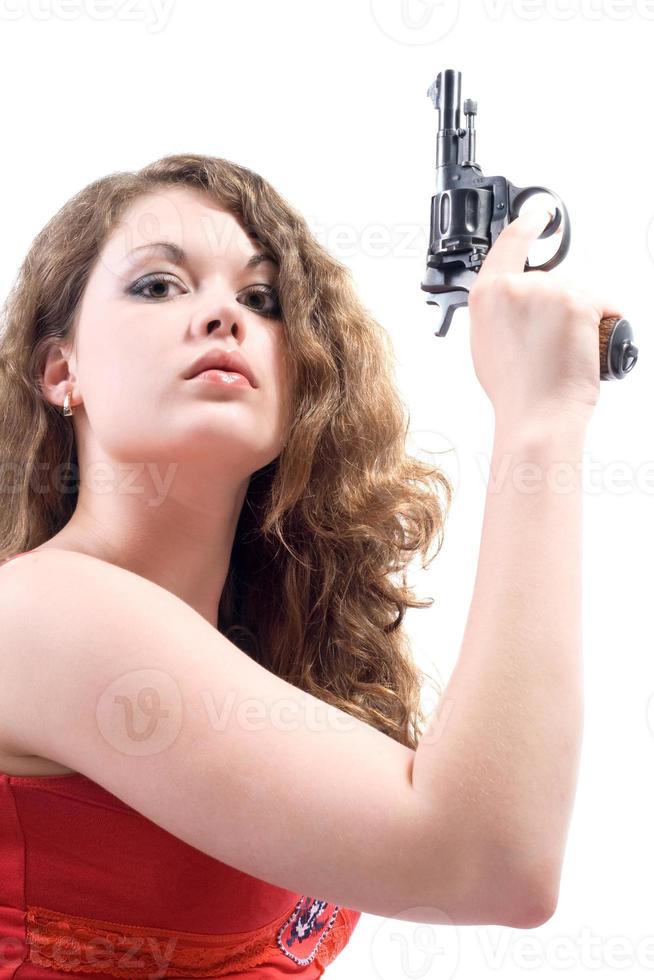 giovane donna con un' revolver. isolato su bianca foto