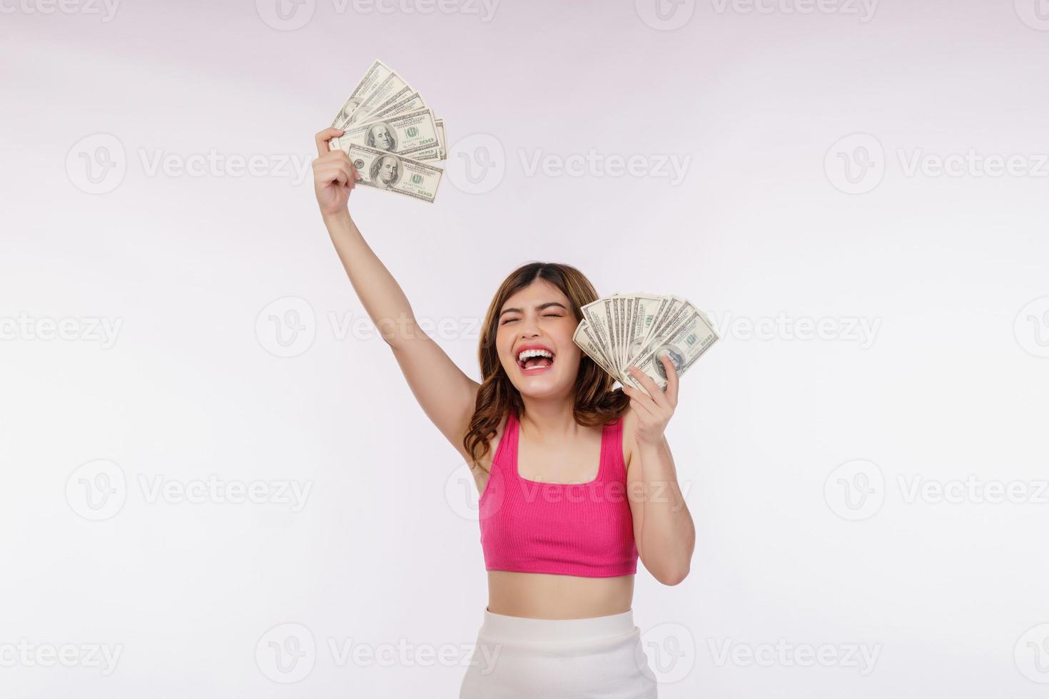 ritratto di eccitato giovane donna Tenere mazzo di dollari banconote isolato al di sopra di bianca sfondo foto