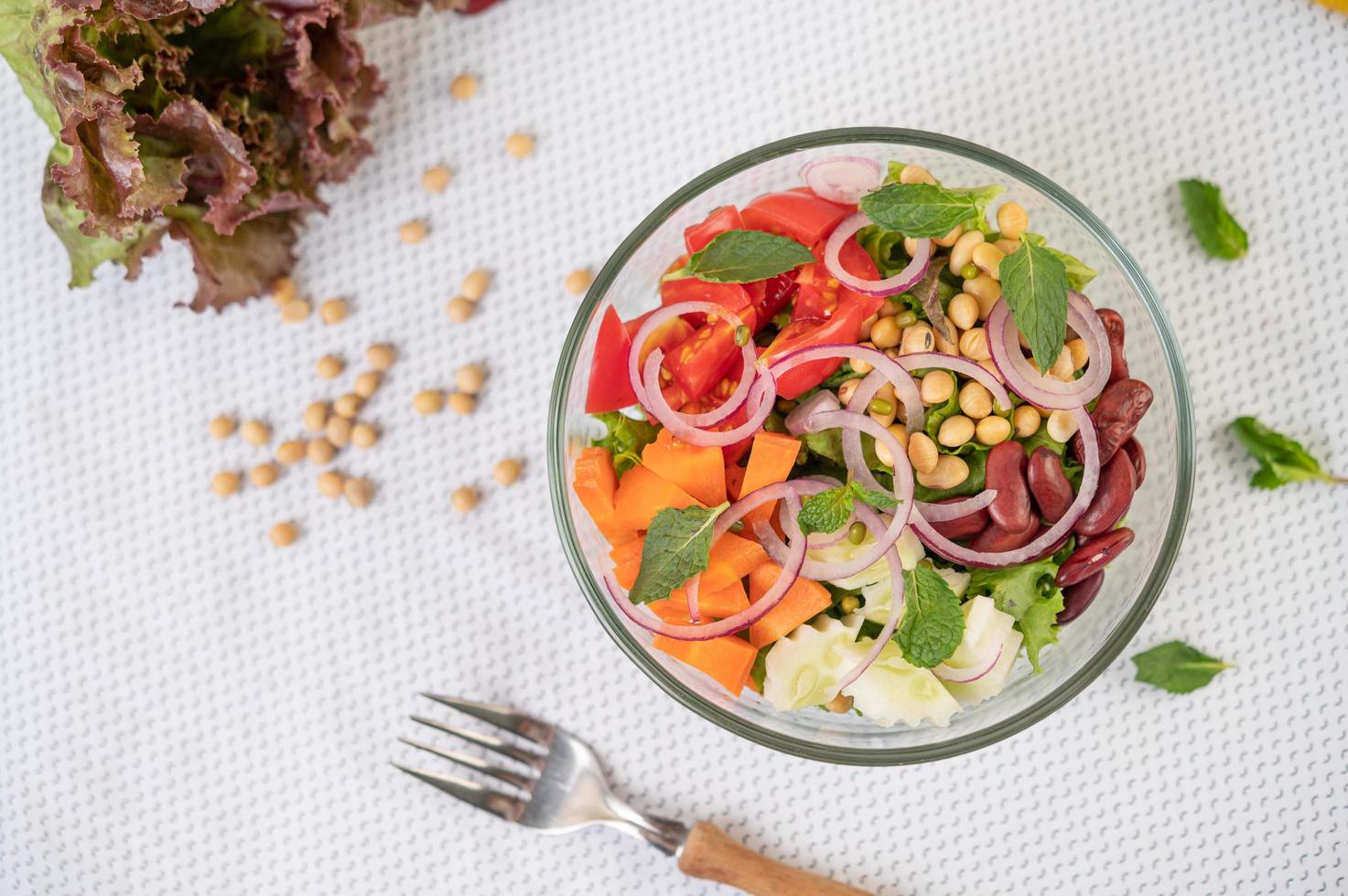 insalata di frutta e verdura fresca in una ciotola di vetro foto