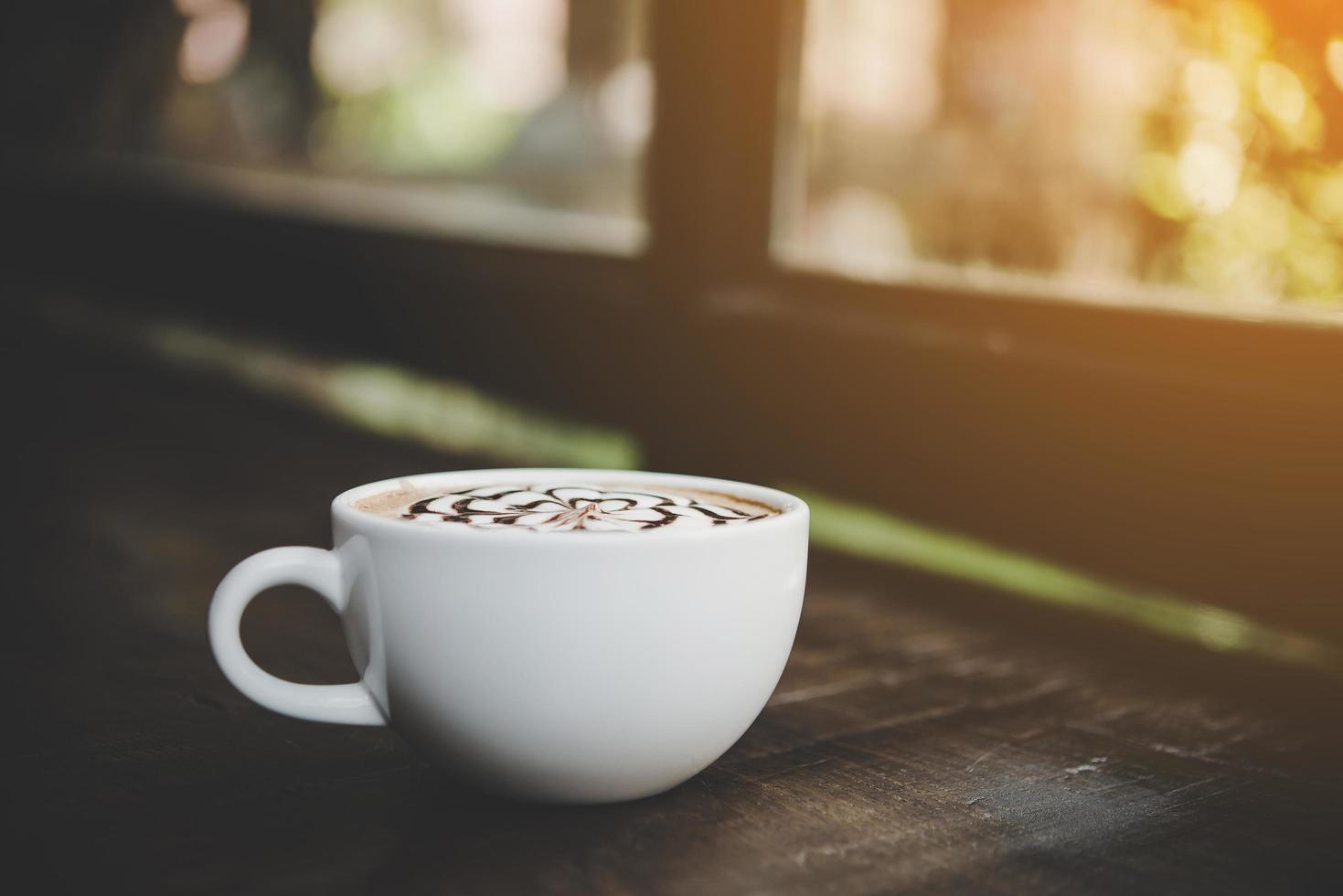 una tazza di caffè su un tavolo di legno foto