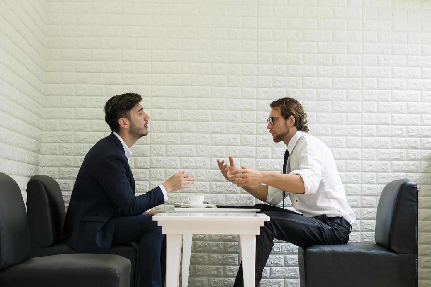 giovane imprenditore parlando con un collega in un moderno business lounge foto
