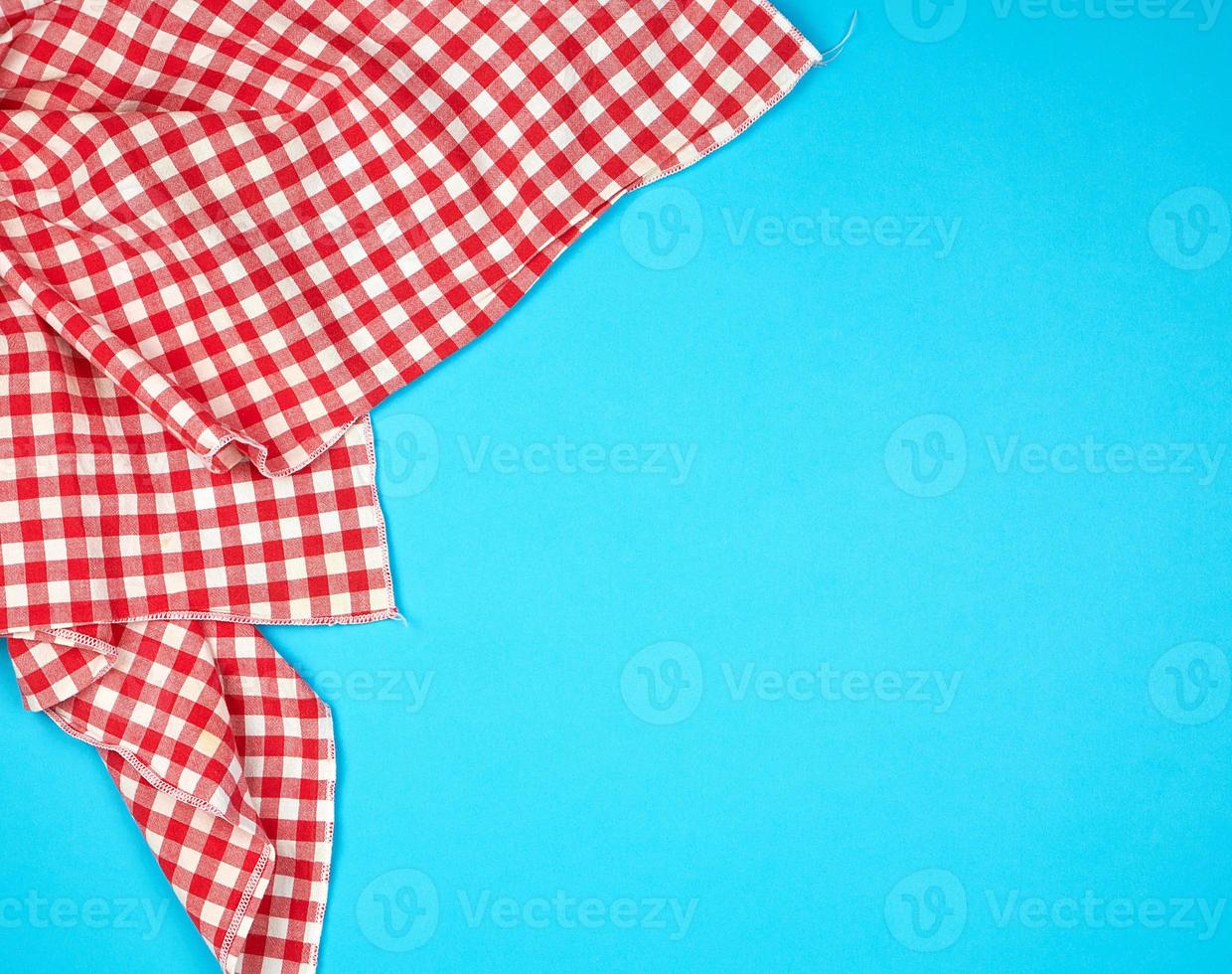 bianca rosso scacchi cucina asciugamano su un' blu sfondo foto