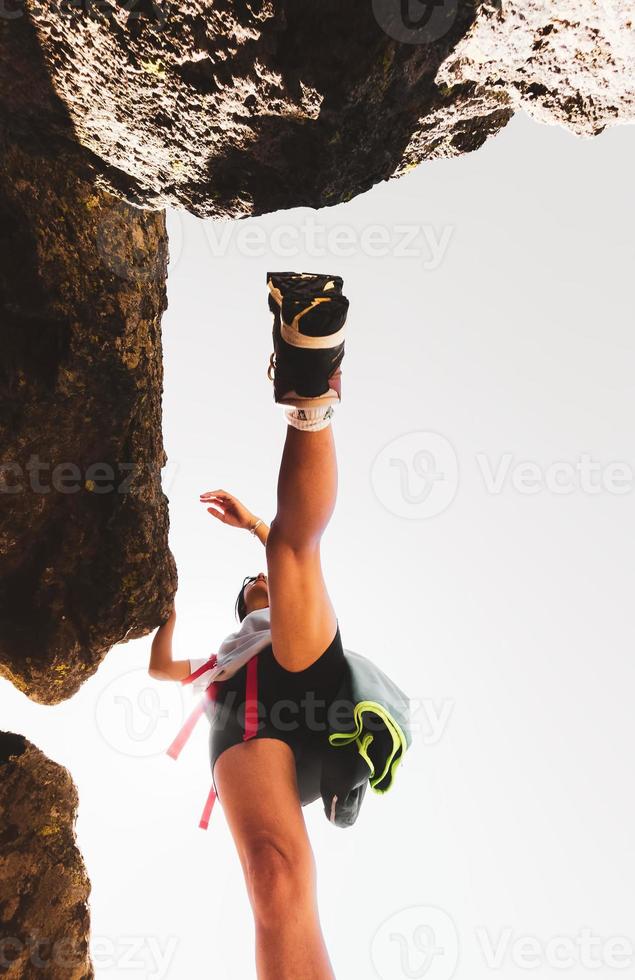 Basso Visualizza femmina escursionista arrampicata roccioso terreno all'aperto nel montagne. messa a fuoco su il stivale foto