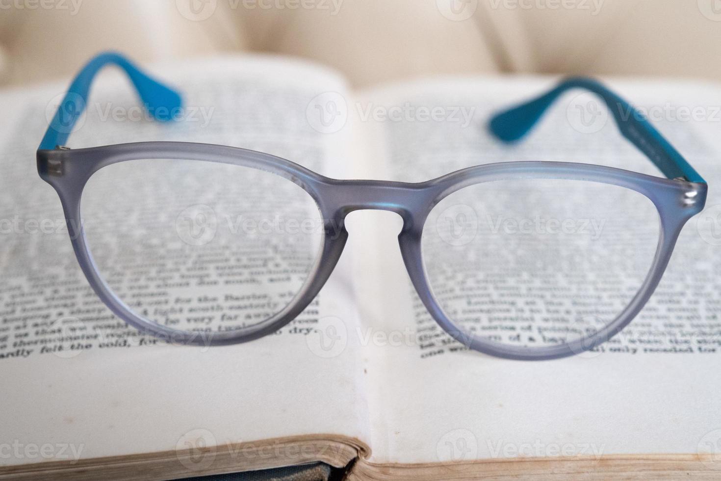 leggero blu lettura bicchieri isolato su un' libro foto