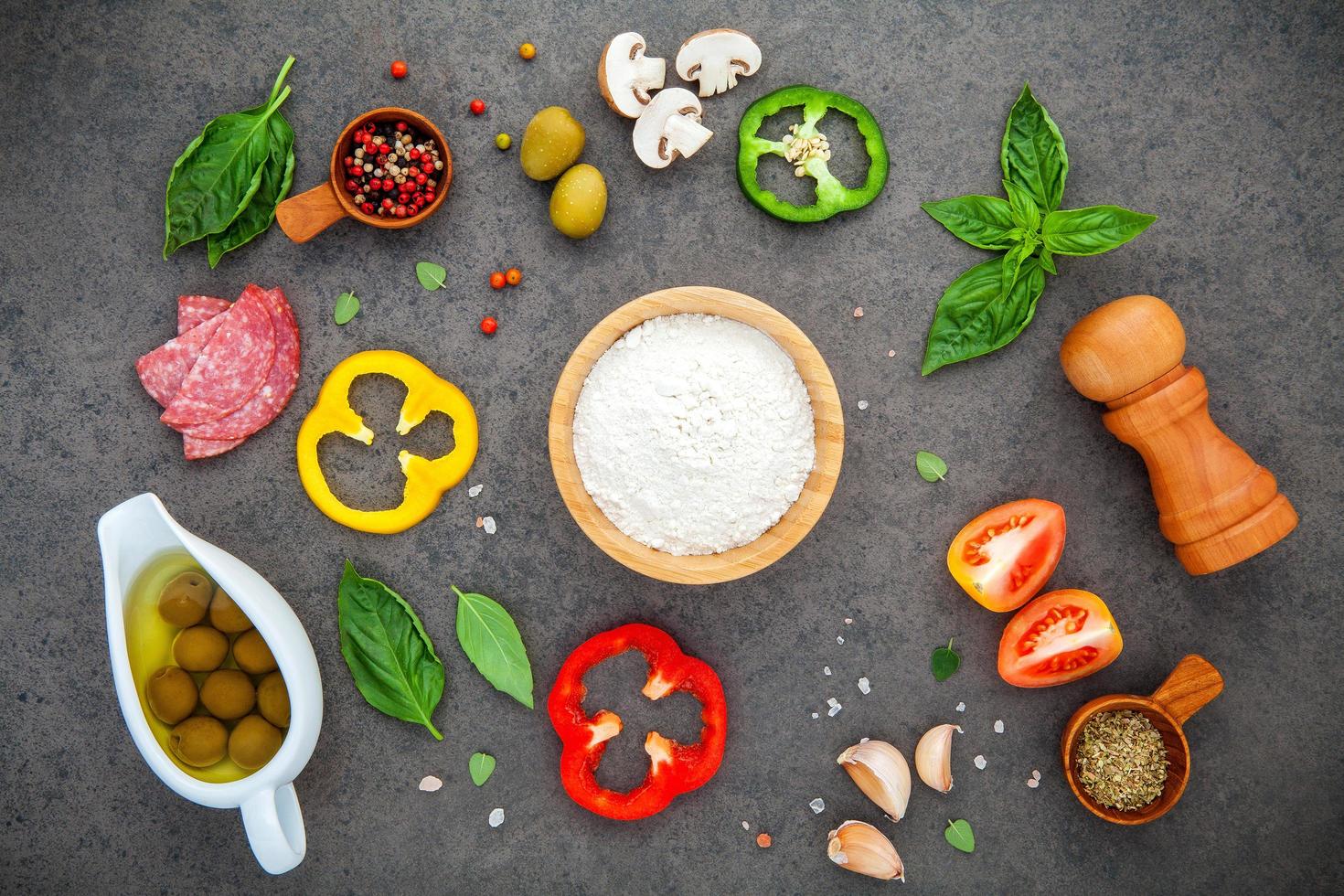 vista dall'alto degli ingredienti della pizza su uno sfondo grigio scuro foto