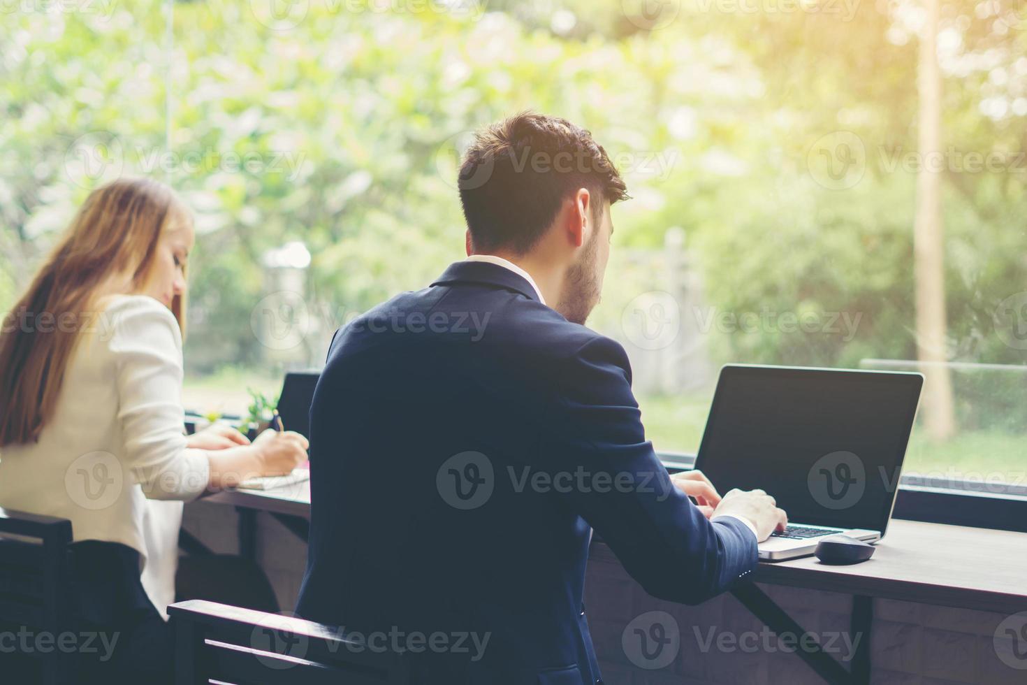 giovane uomo d'affari che lavora al computer portatile in ufficio foto