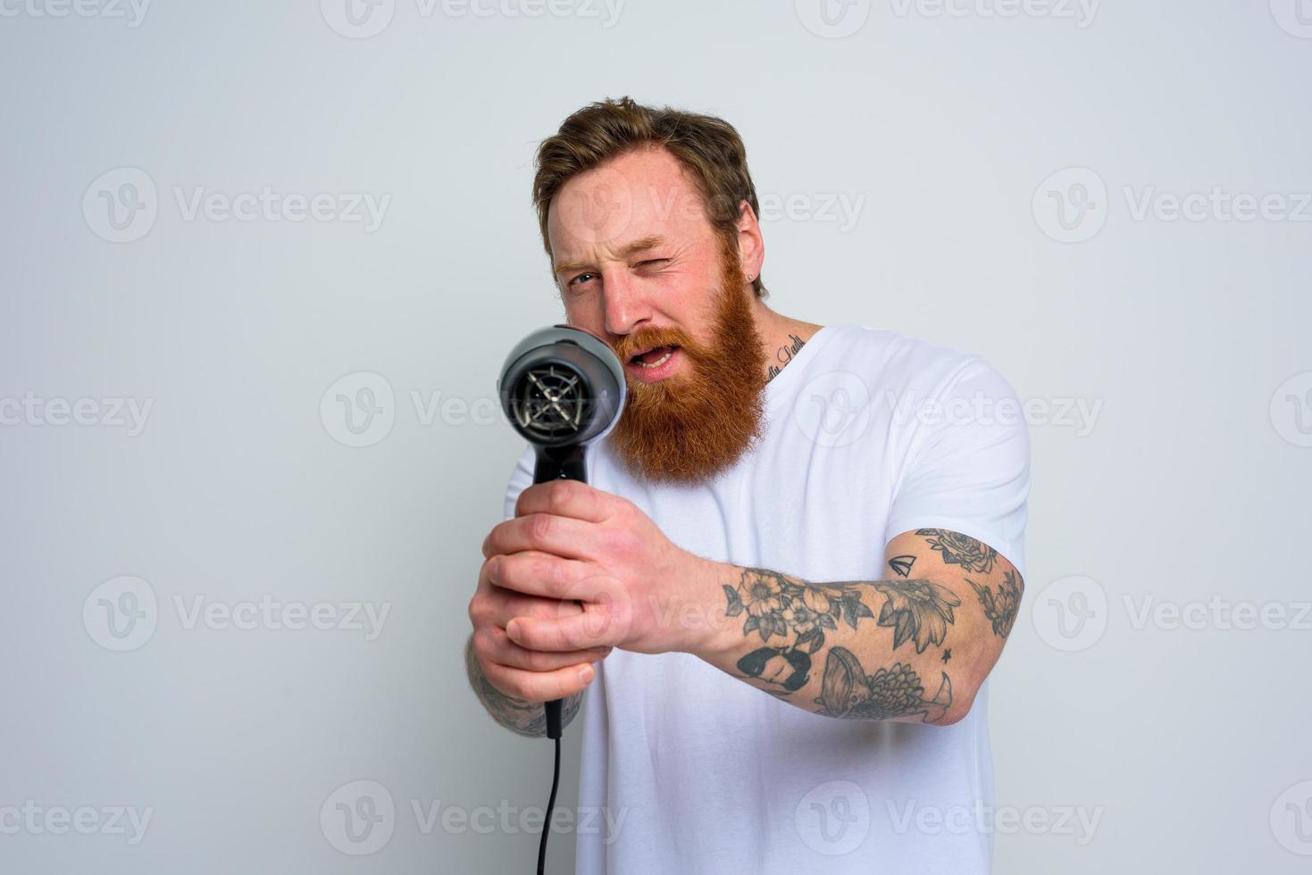 grave uomo con barba giocare con capelli dryas un' pistola foto