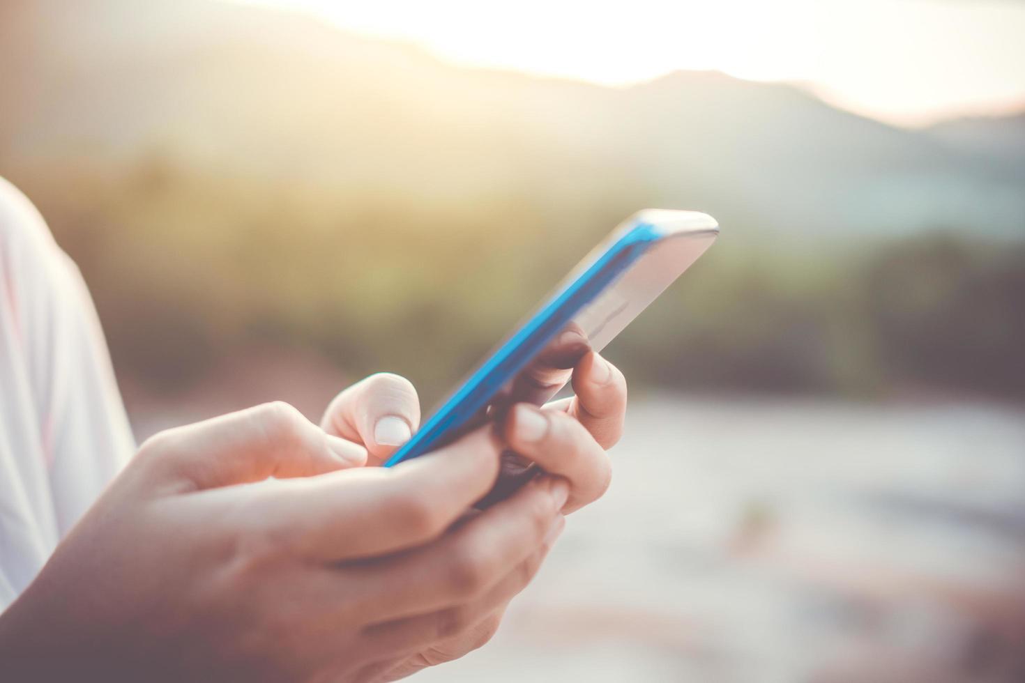 mano della donna utilizzando uno smartphone foto