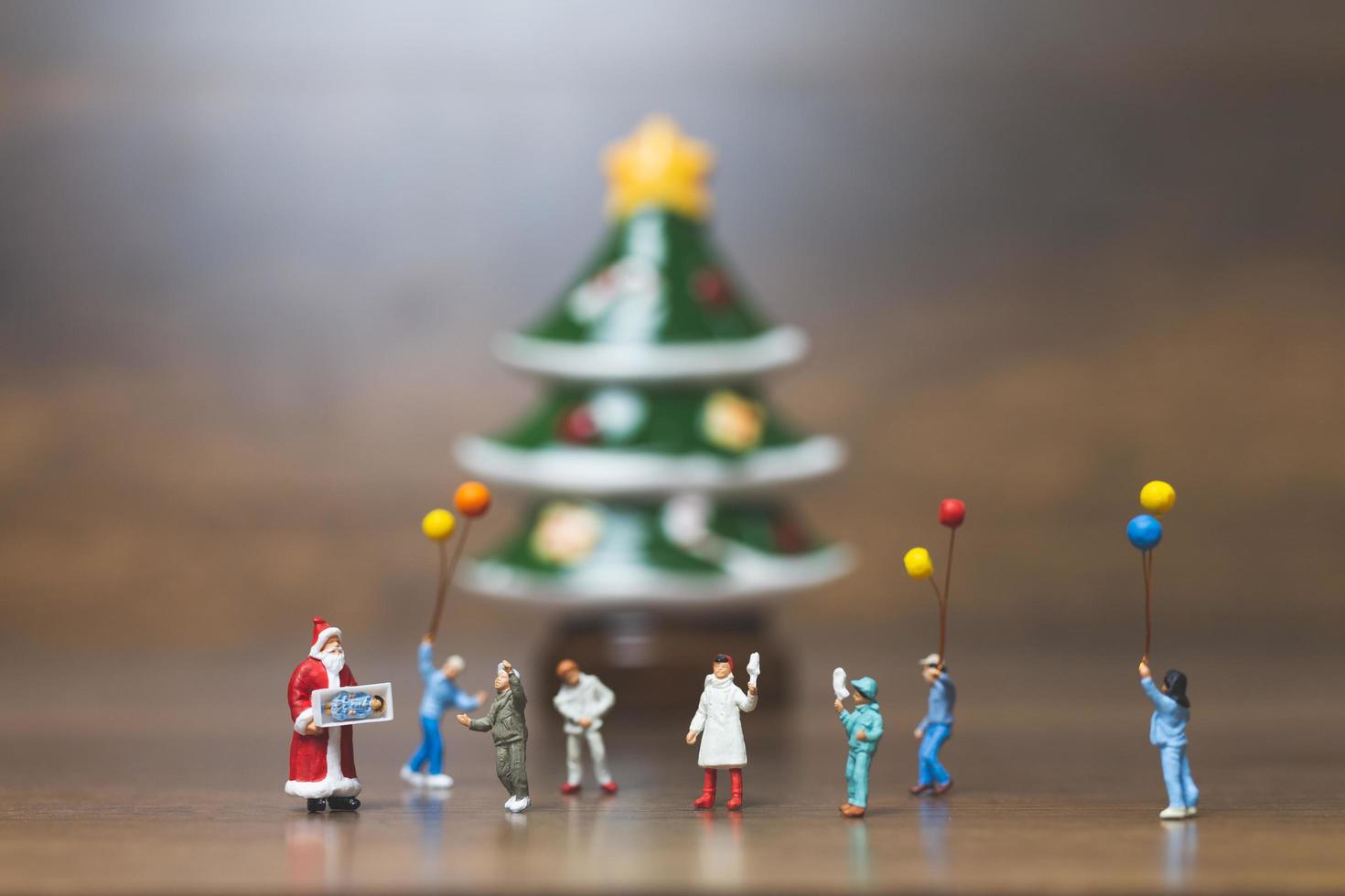 famiglia felice in miniatura che celebra il concetto di natale, natale e felice anno nuovo foto