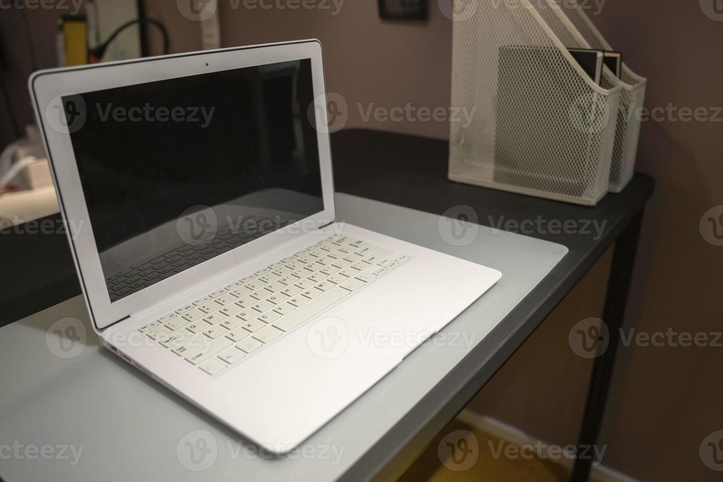 un Aperto il computer portatile con un' vuoto schermo su un' scrivania nel il ufficio o a casa foto