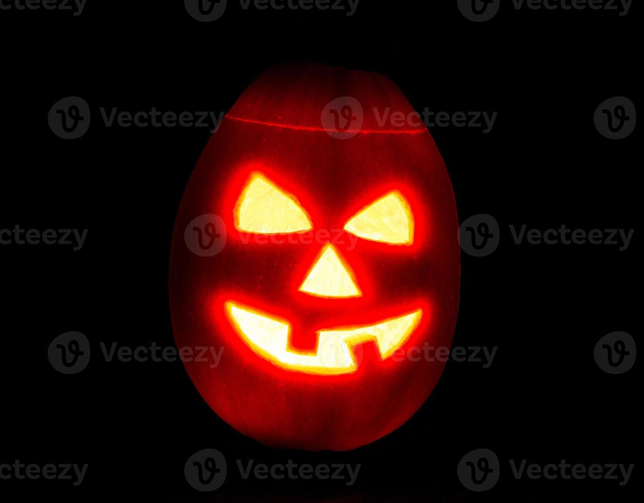 Halloween zucca jack-o-lanterna candela illuminato, isolato su nero foto