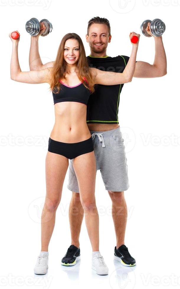 atletico uomo e donna con manubri su il bianca foto