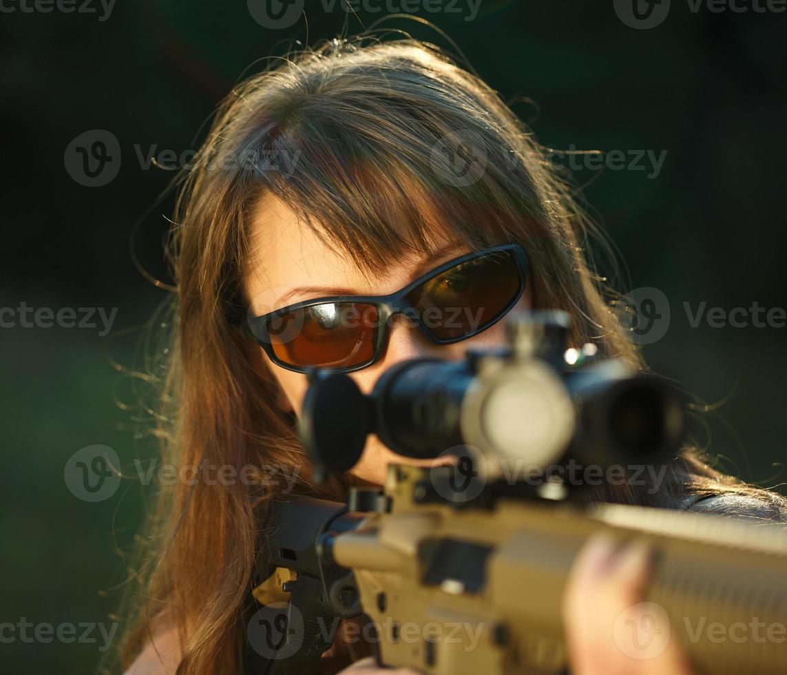 ragazza con un' pistola per trappola tiro e tiro bicchieri mirando a un' bersaglio foto