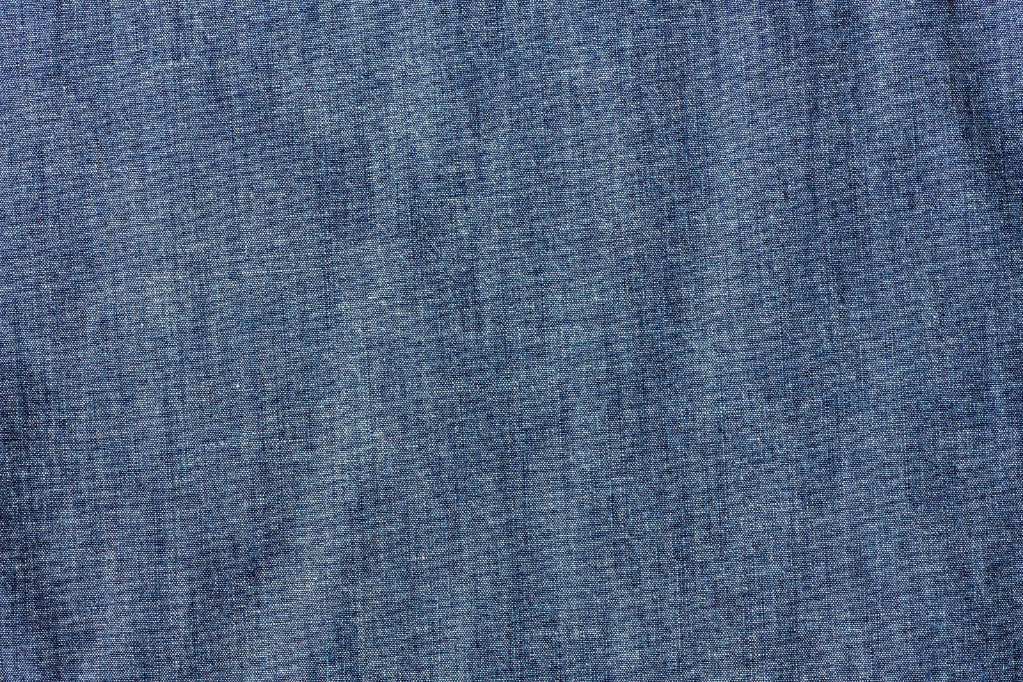 avvicinamento di chambray jeans tessile, stoffa sfondo foto