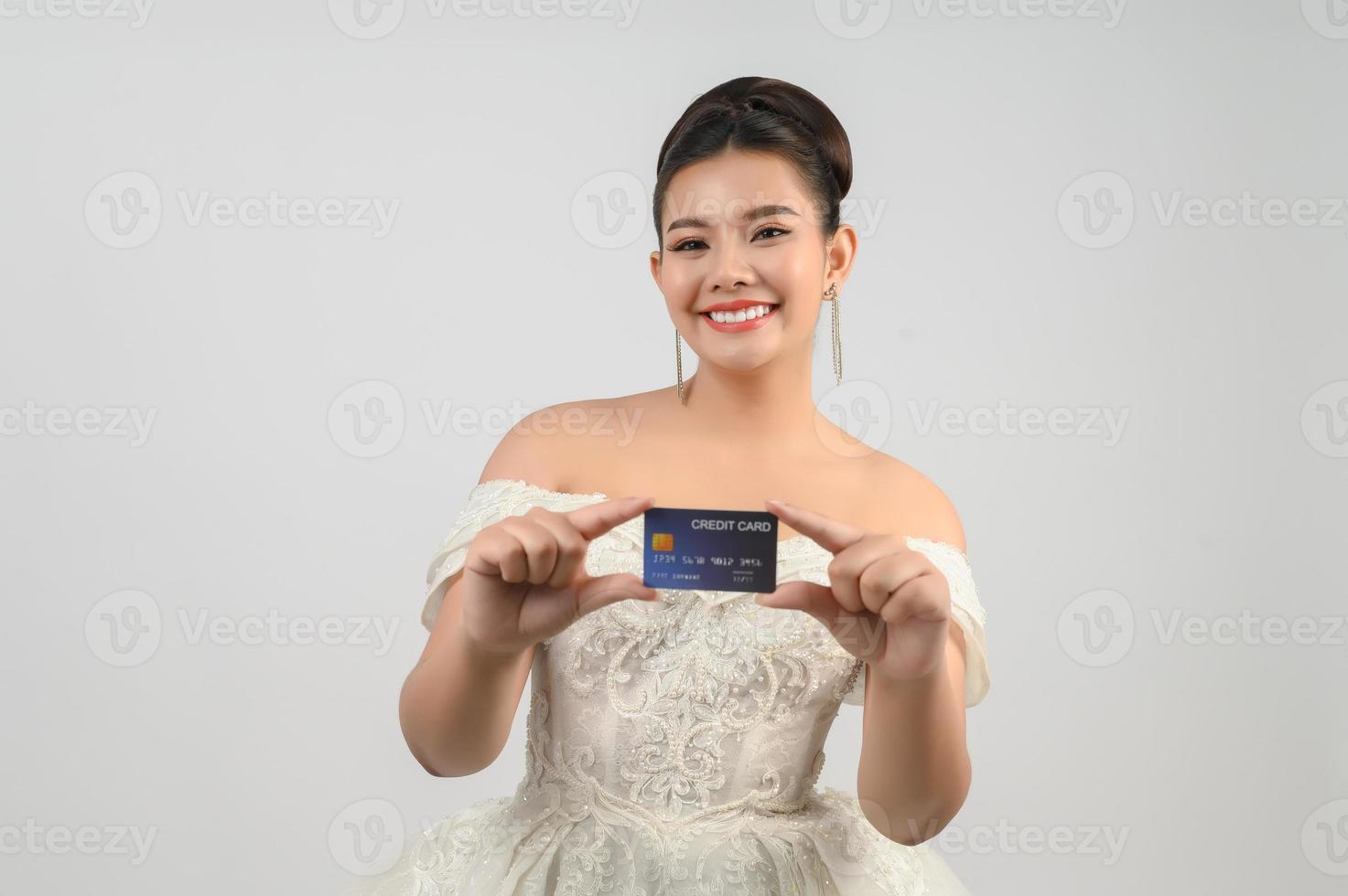 giovane asiatico bellissimo sposa spedizione con credito carta nel mano foto