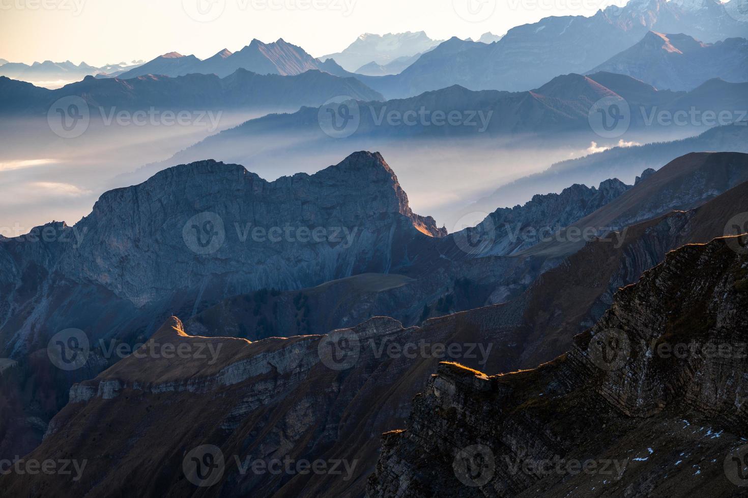 freddo bluastra montagna paesaggio nel nebbia a Alba foto