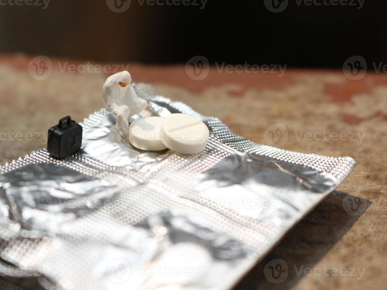 un' vicino su di un' miniatura figura di un' ricercatore ricercando un' droga. Salute foto concetto.