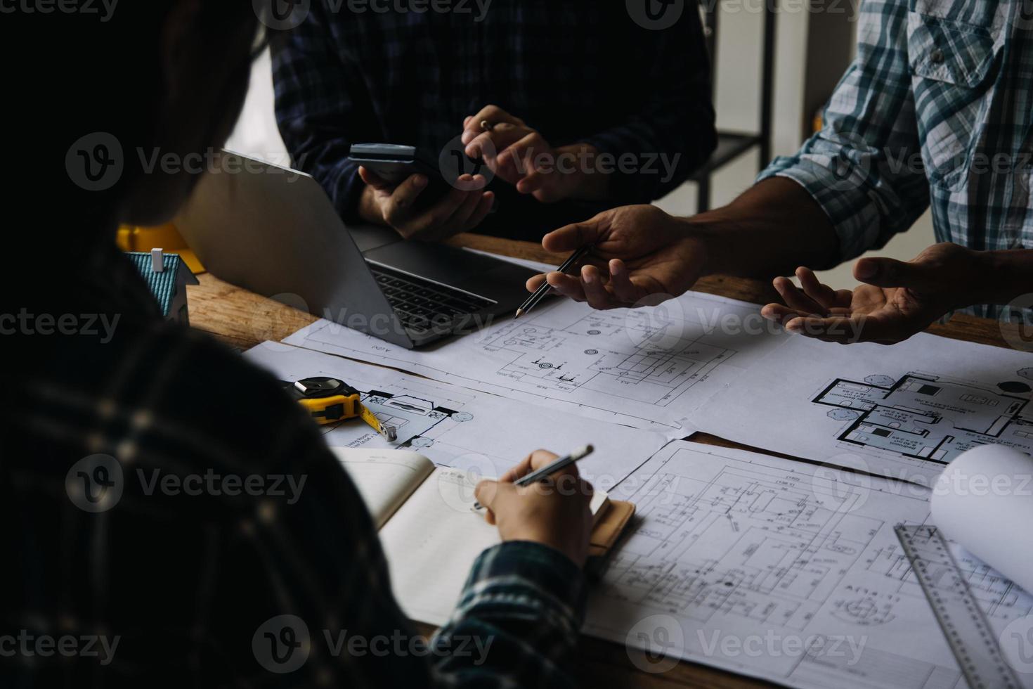 costruzione e struttura concetto di ingegnere Lavorando disegno su planimetria incontro per progetto Lavorando con compagno su modello edificio e ingegneria utensili nel Lavorando luogo, costruzione concetto foto