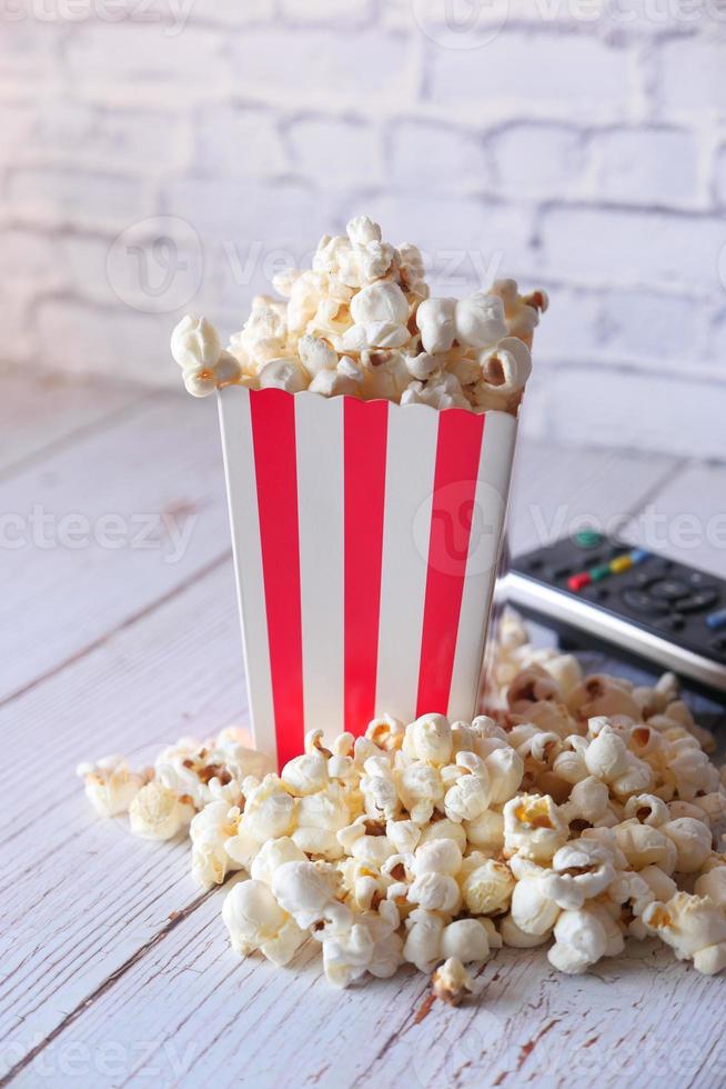 popcorn e un telecomando della tv foto