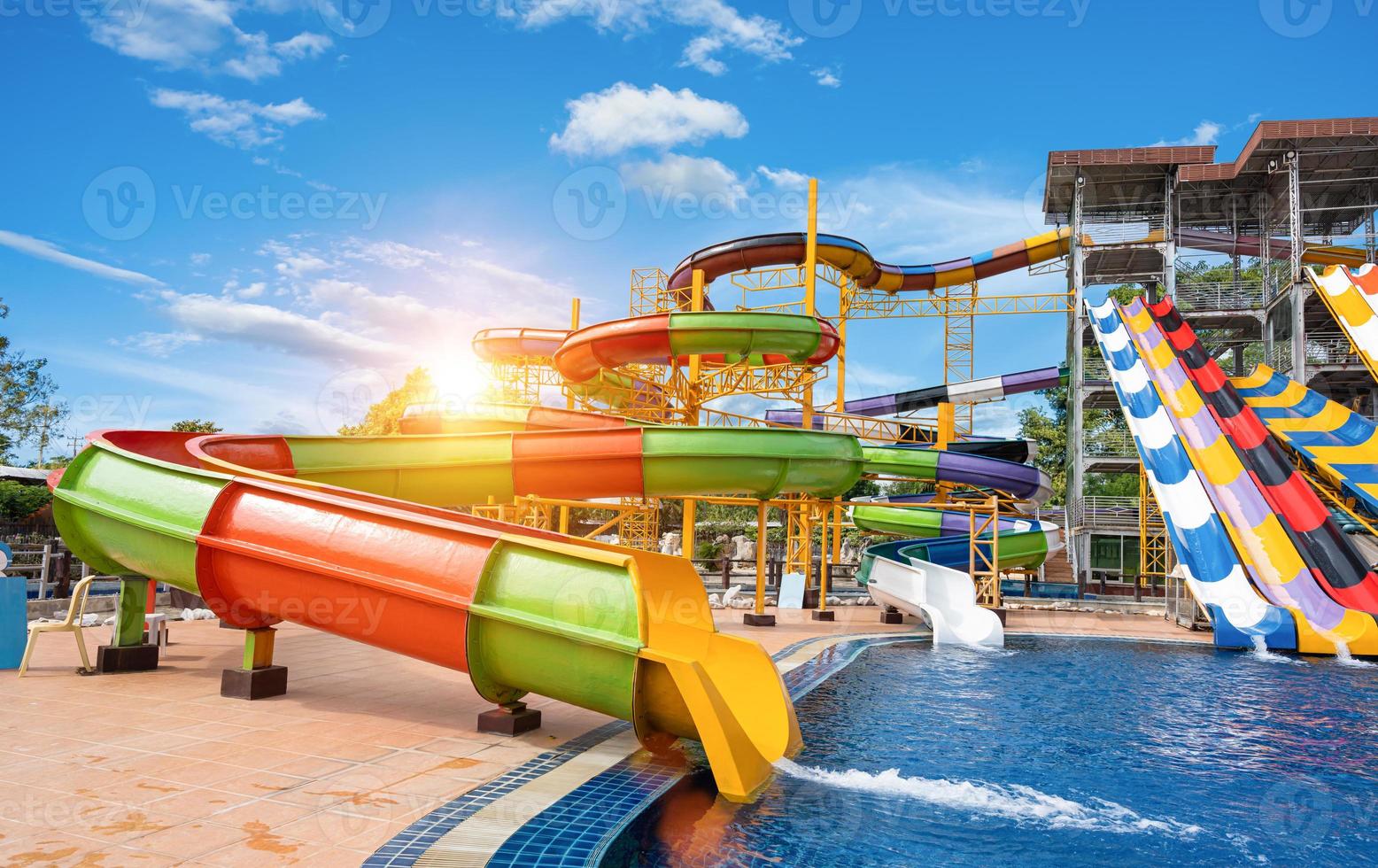 nuoto piscina con acqua scivoli nel acqua parco su soleggiato giorno. estate divertimento attività, vacanza tempo libero concetto. foto