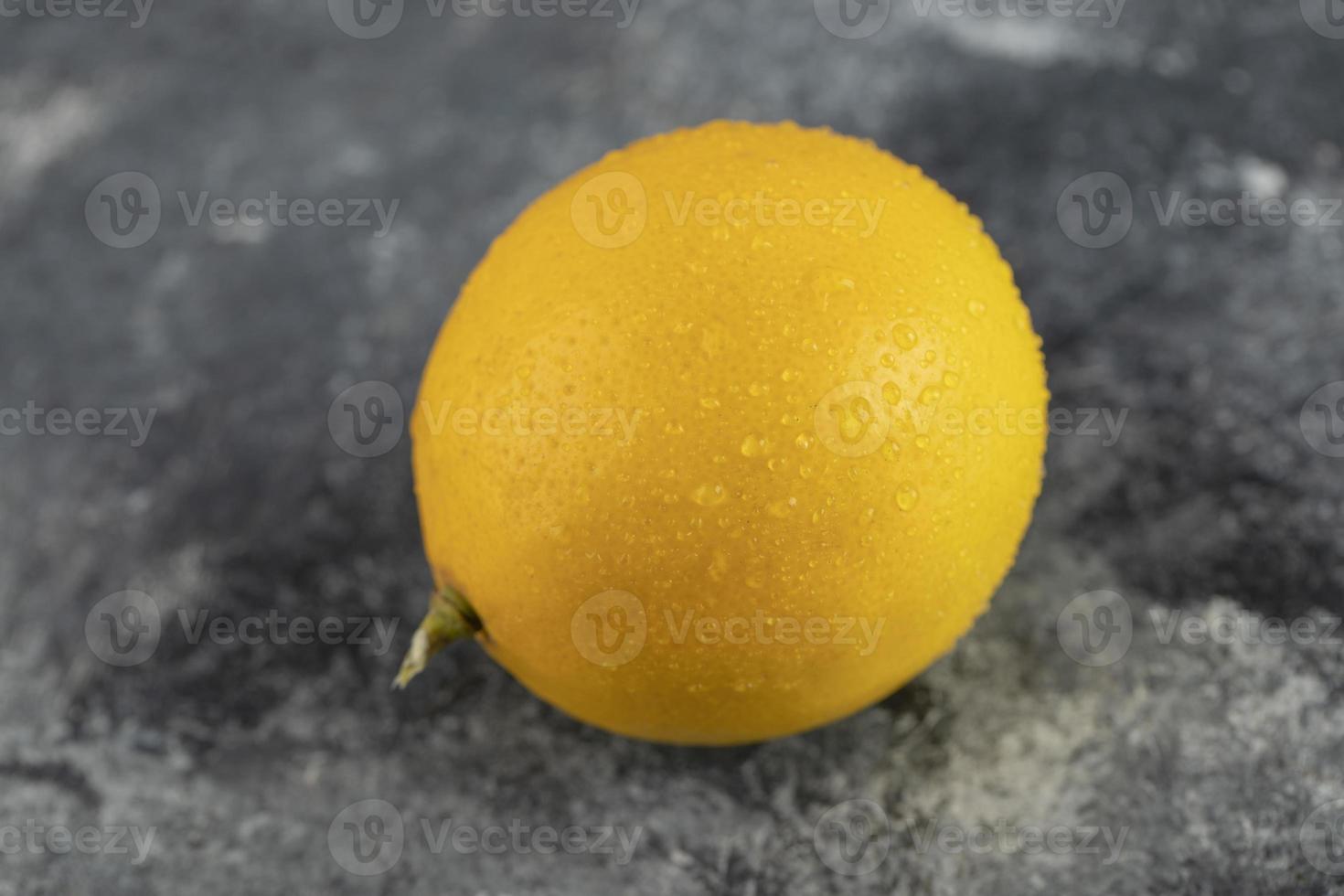 un giallo limone maturo su uno sfondo di marmo foto