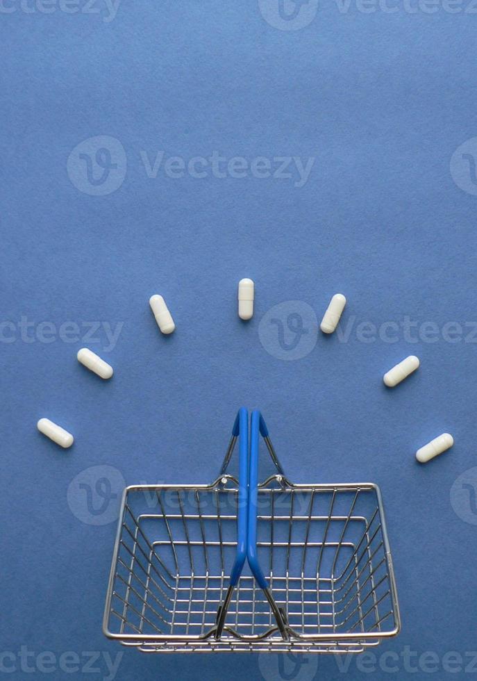 shopping carrello con medicina pillole nel imballare su classico blu sfondo con copia spazio. creativo idea per farmacia, in linea farmacia, Salute stile di vita e farmaceutico azienda attività commerciale concetto. foto