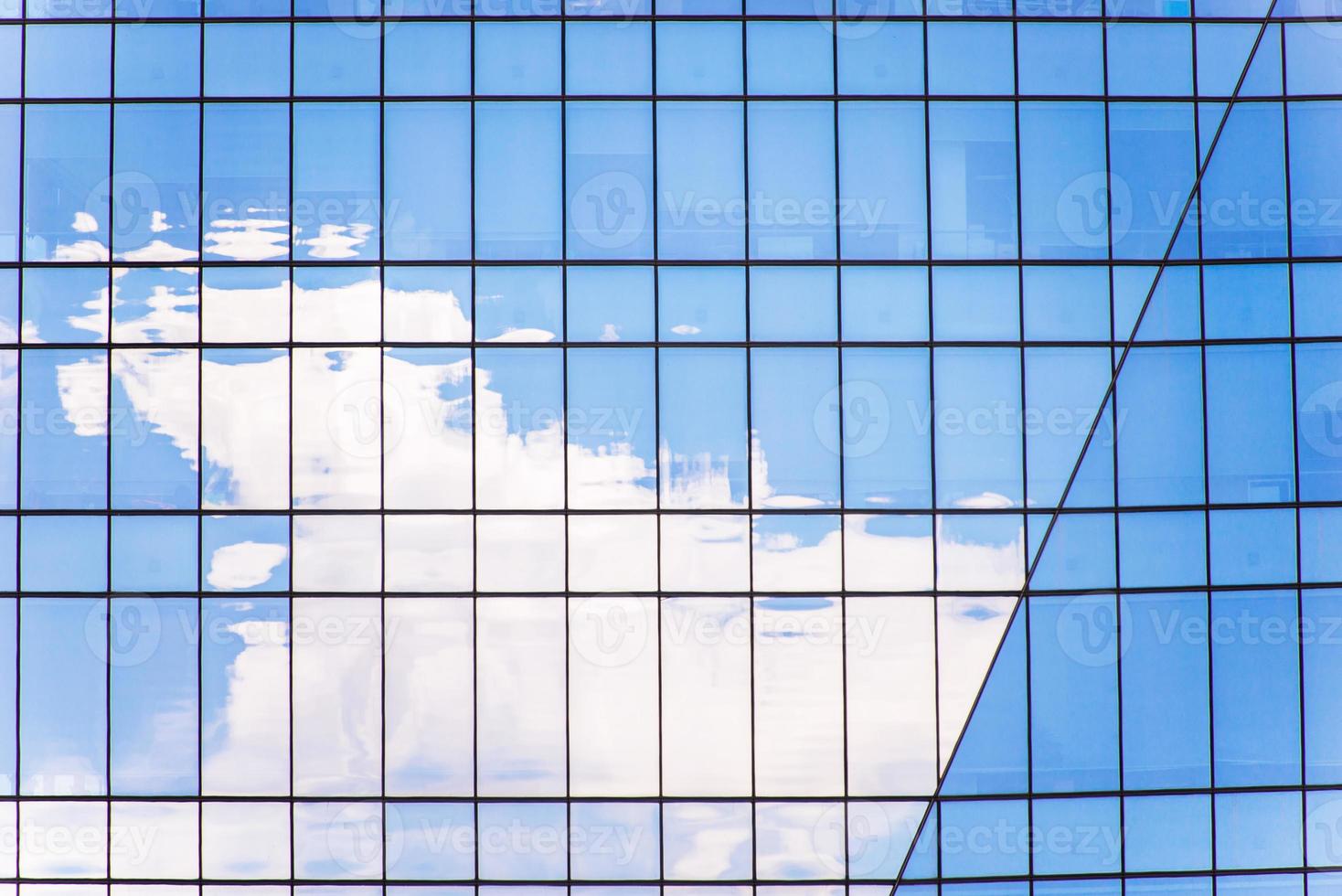 il riflessione di nube nel il finestre di moderno ufficio edificio foto