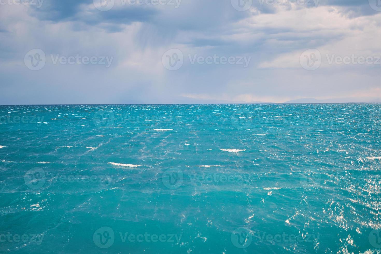 vista sul mare con una chiara linea dell'orizzonte e cielo nuvoloso foto
