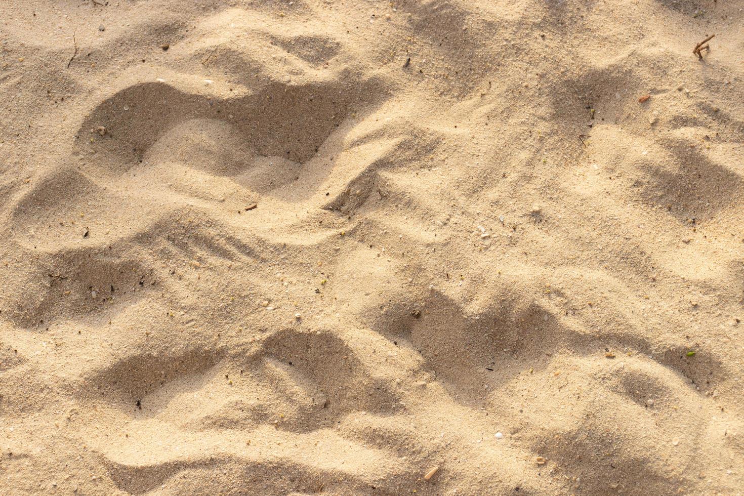 sabbia sulla trama spiaggia per sfondo estivo foto