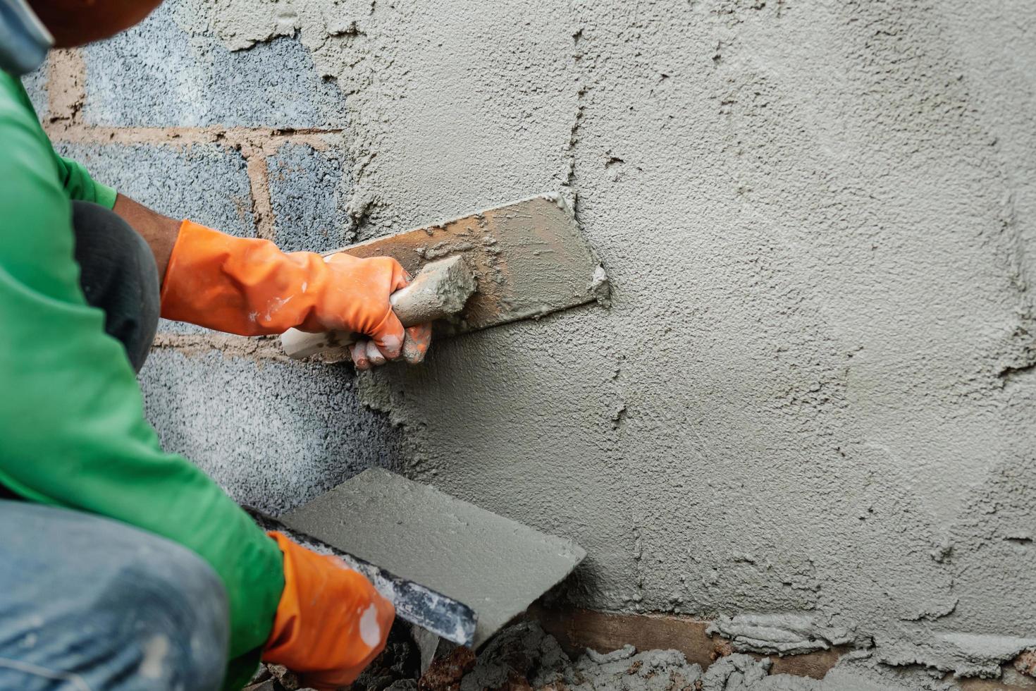 lavoratore intonacatura cemento su parete per edificio Casa foto