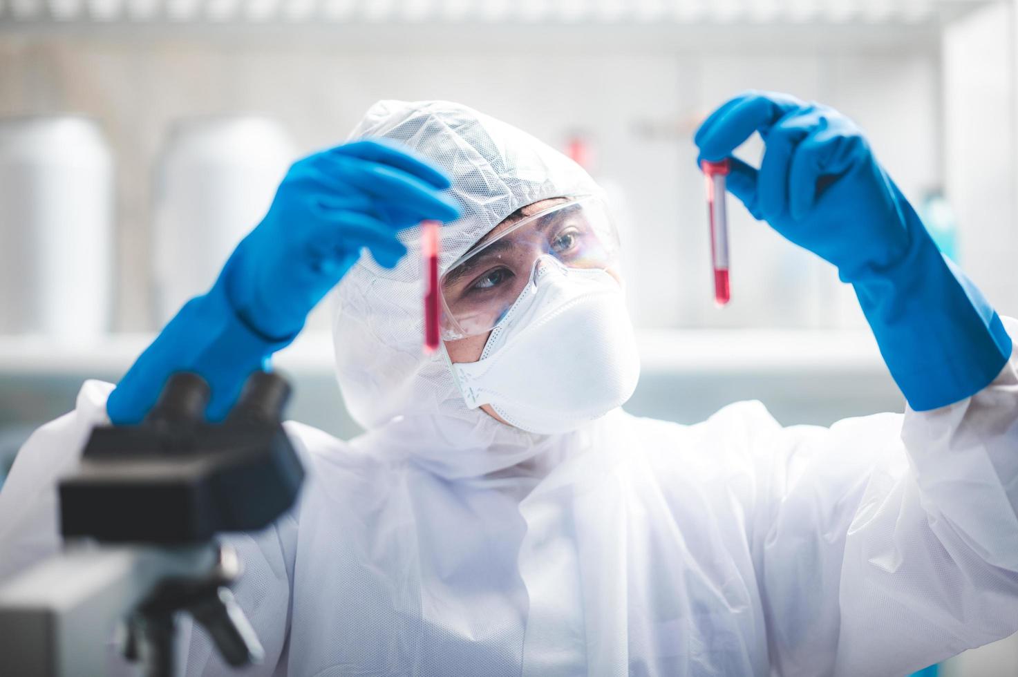 scienziato che studia campioni di sangue foto