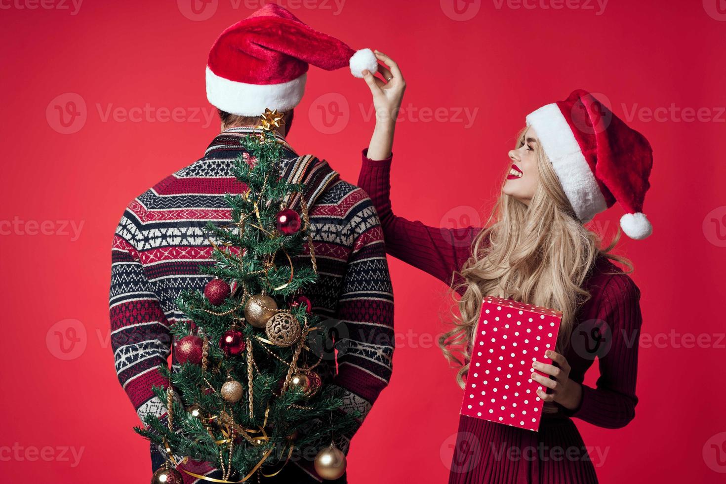 allegro giovane coppia nel Santa cappelli Natale albero giocattoli decorazioni foto