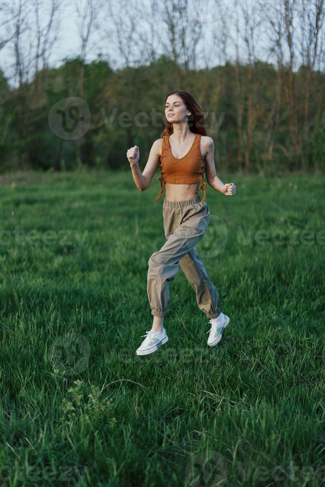 un atletico donna corre e treni sua corpo prima il estate stagione nel il parco foto