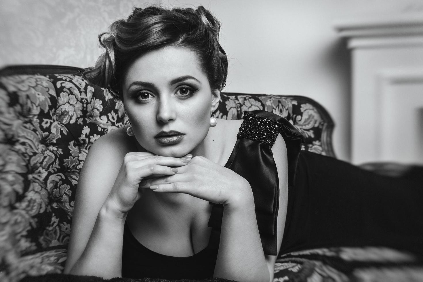 modella e attrice giovane ragazza bruna sul divano primo piano, in bianco e nero foto