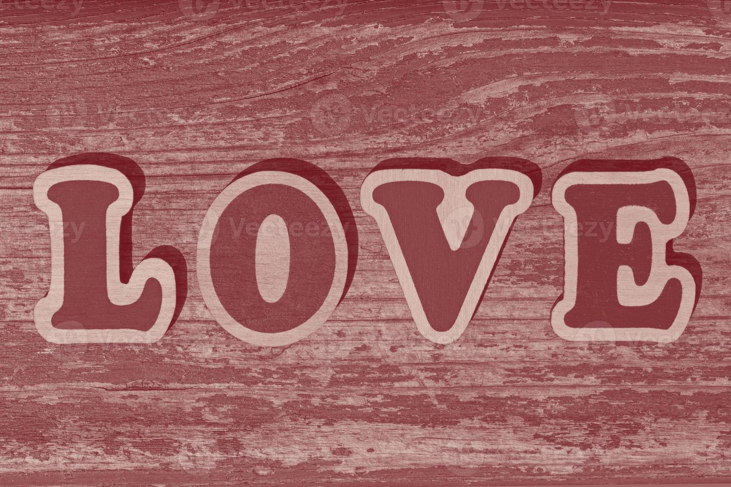 parola amore fatto di di legno lettere su di legno tavola foto