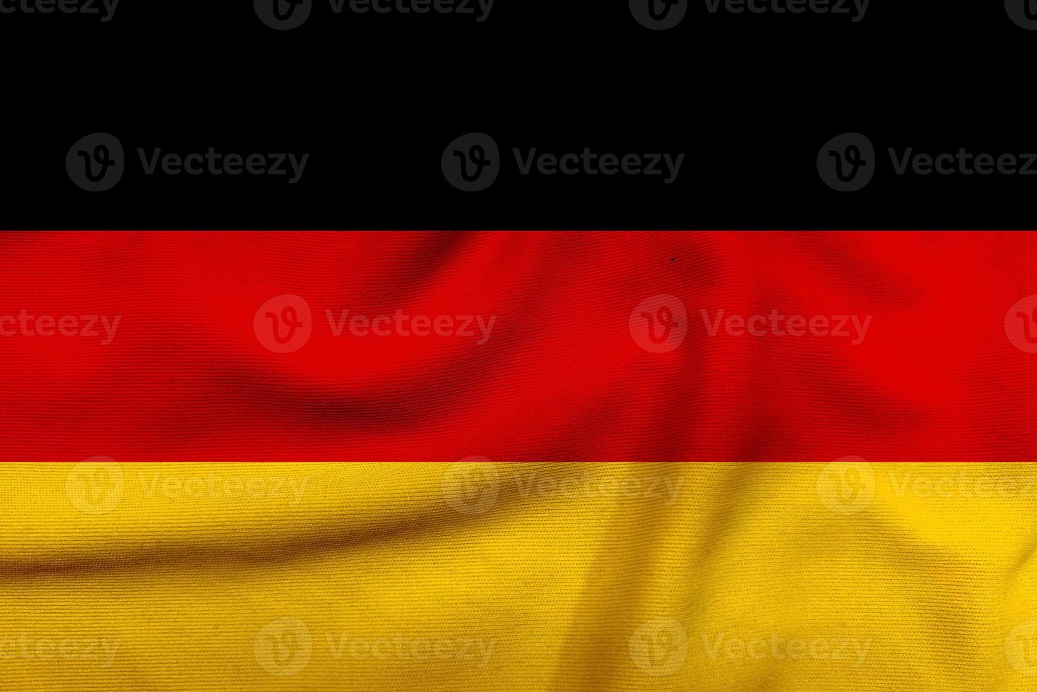Germania bandiera su il strutturato stoffa, contemporaneo prendere su il Nero, rosso, e oro bandiera di Germania foto
