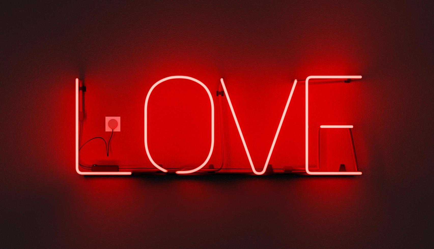segno al neon rosso con la parola amore, illustrazione 3d foto