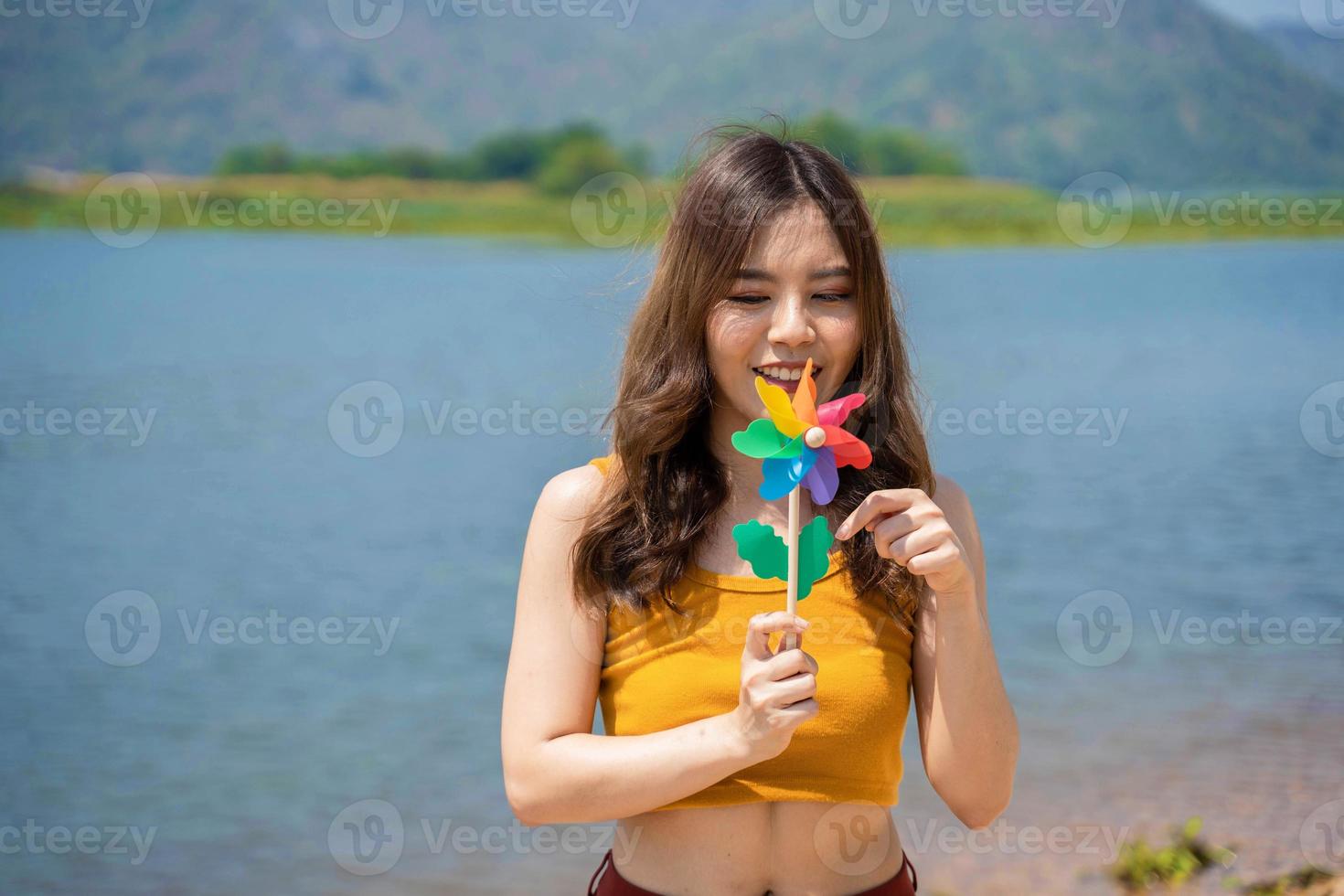 giovane lgbt donna Tenere colorato turbina su il spiaggia. sostenitori di il lgbt Comunità foto