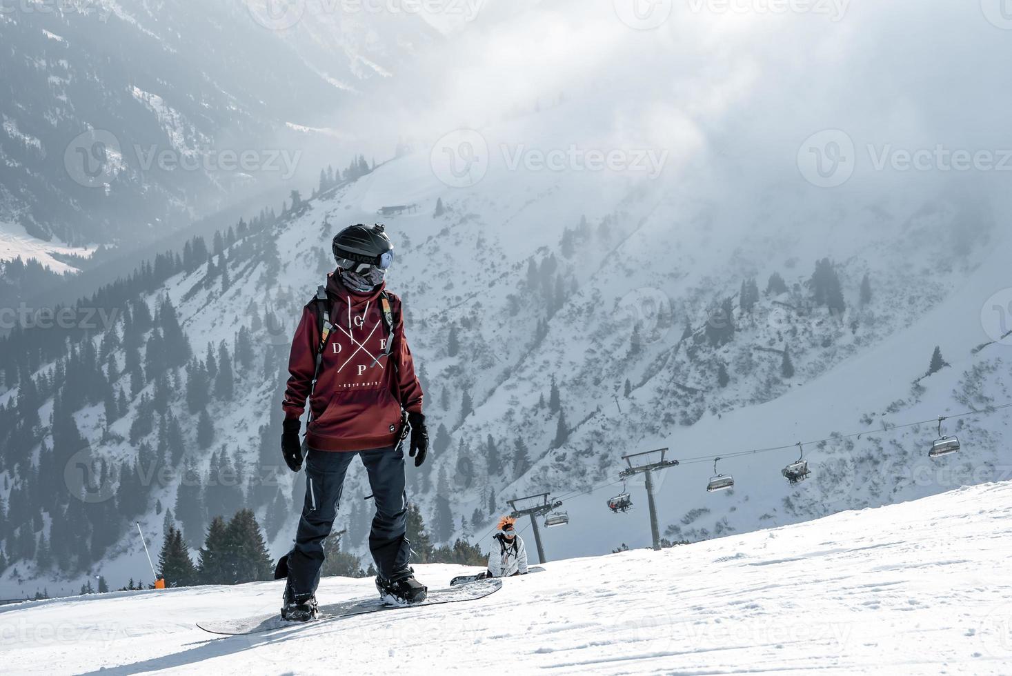 turista in piedi su picco di neve coperto montagna durante vacanza foto