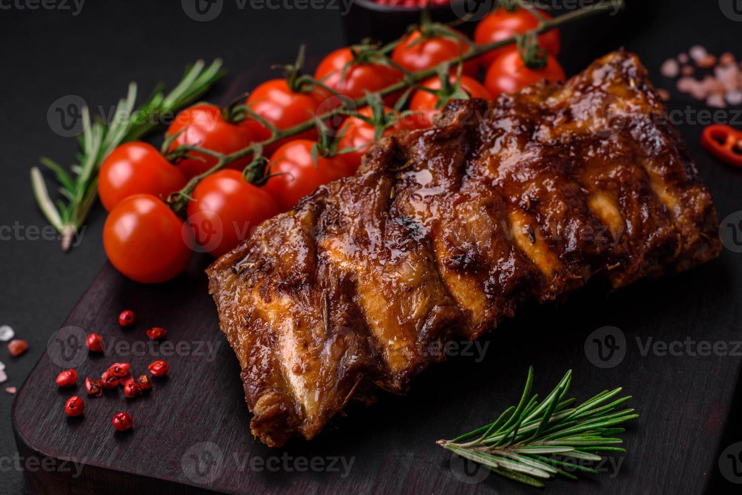 delizioso grigliato Maiale costolette con salsa, spezie e erbe aromatiche foto