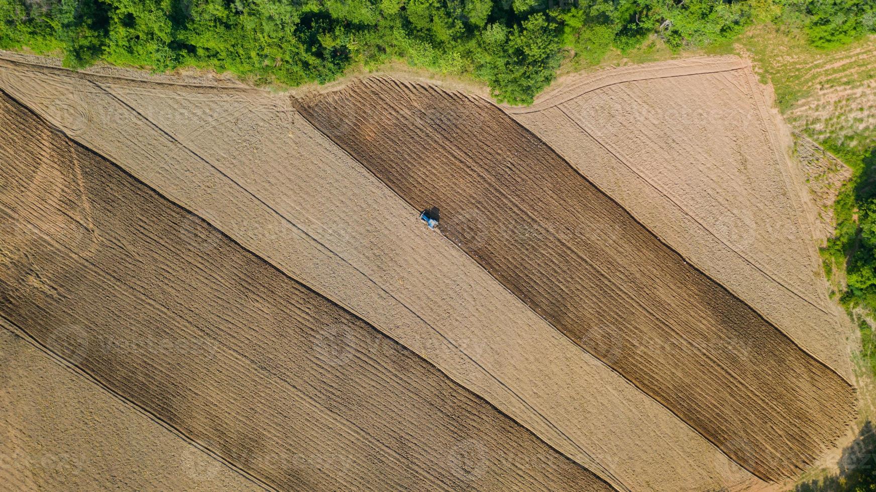 vista dall'alto di veicoli per trattori agricoli che lavorano al campo foto