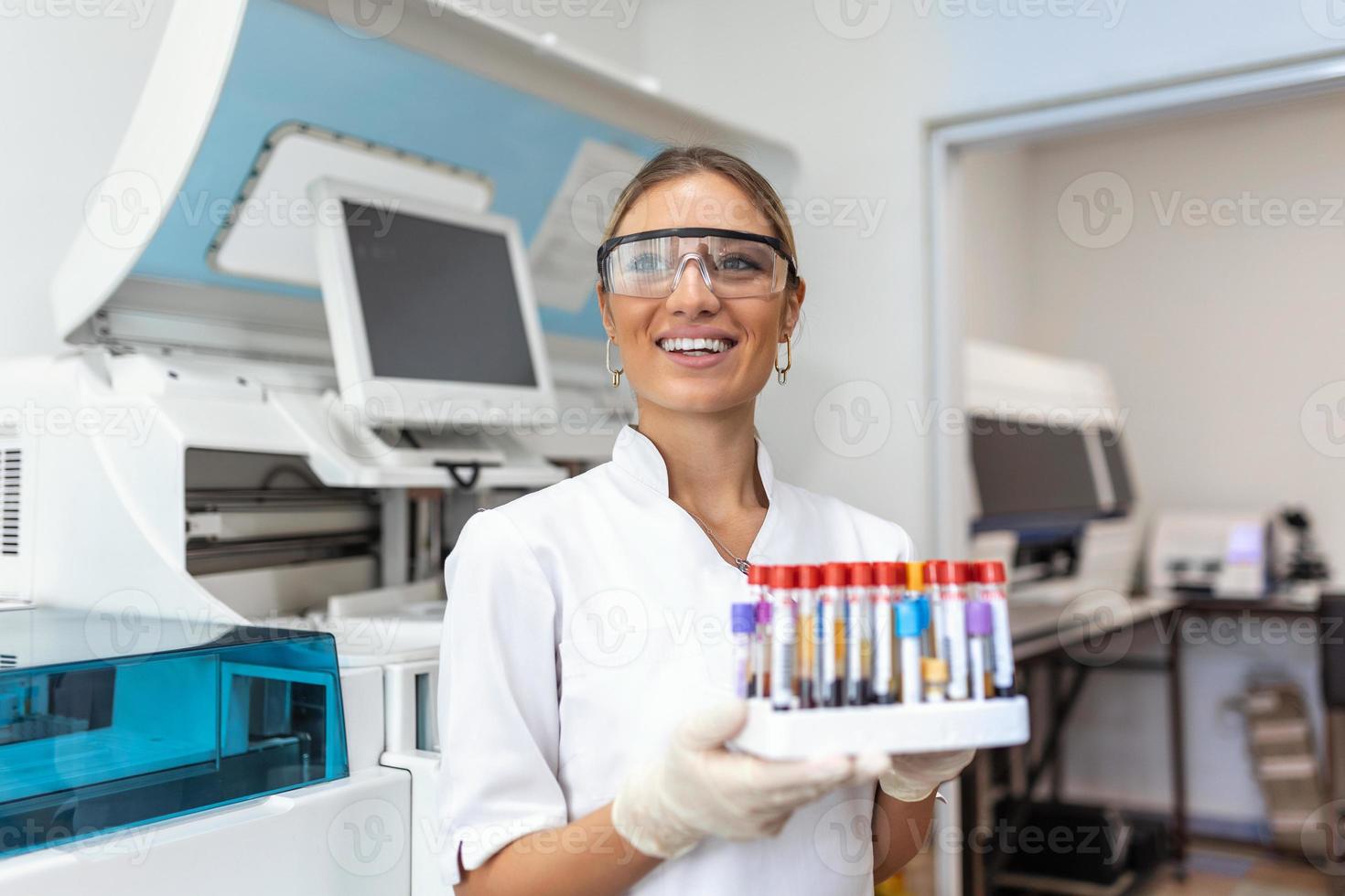 sangue test tubi. femmina scienziato l'esame sangue test tubi a sua laboratorio dna analisi analisi professione specialista clinico esperto medicina assistenza sanitaria medico foto