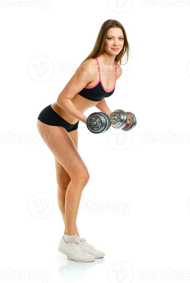 bellissimo atletico donna con manubri fare sport esercizio, isolato su bianca foto