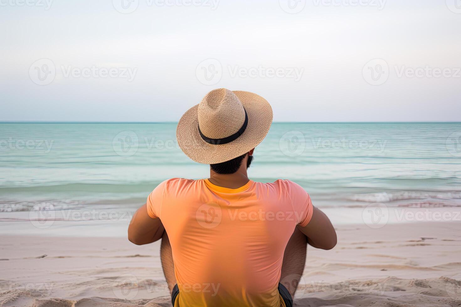 indietro Visualizza di un' uomo indossare un' cappello seduta su un' spiaggia. ai generato foto