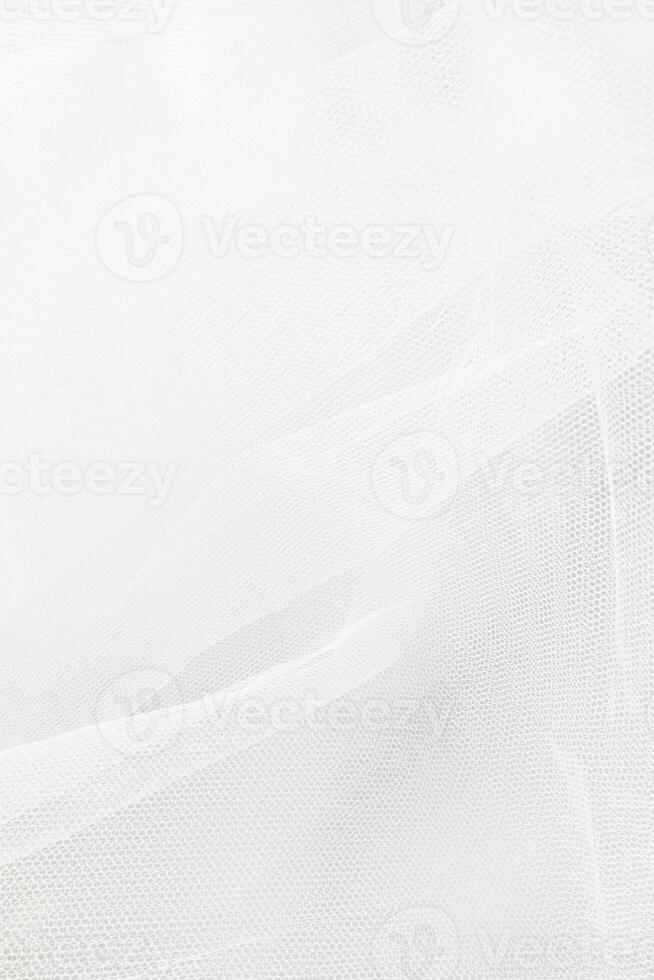 verticale nozze sfondo di il della sposa velo. delicato bianca pieghe di tulle. il concetto di nozze design. foto