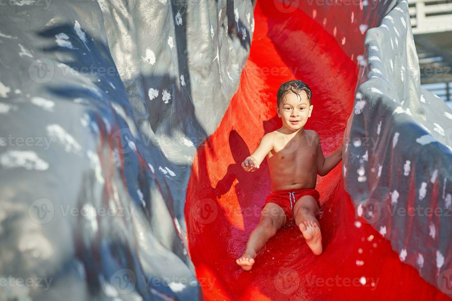 immagine di giovane ragazzo giocando nel all'aperto acqua parco foto