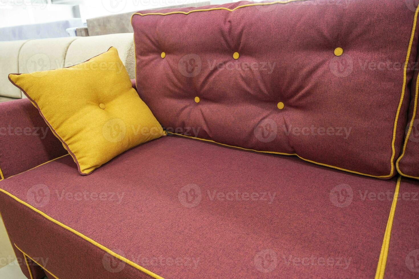 un' morbido nuovo Borgogna divano con un' decorativo cuscino foto