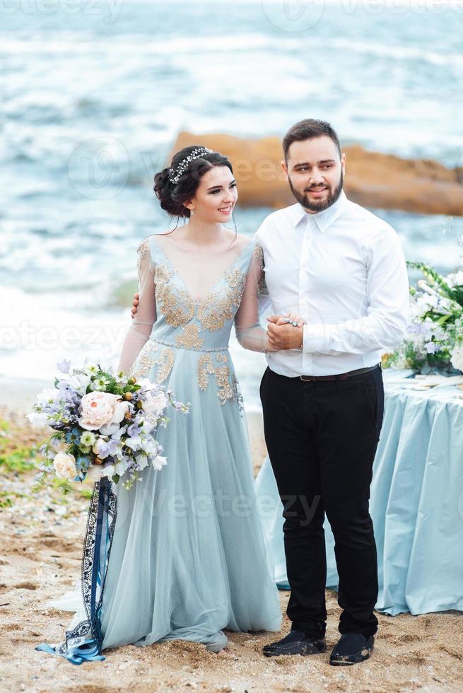 stessa coppia con una sposa in una passeggiata vestito blu foto