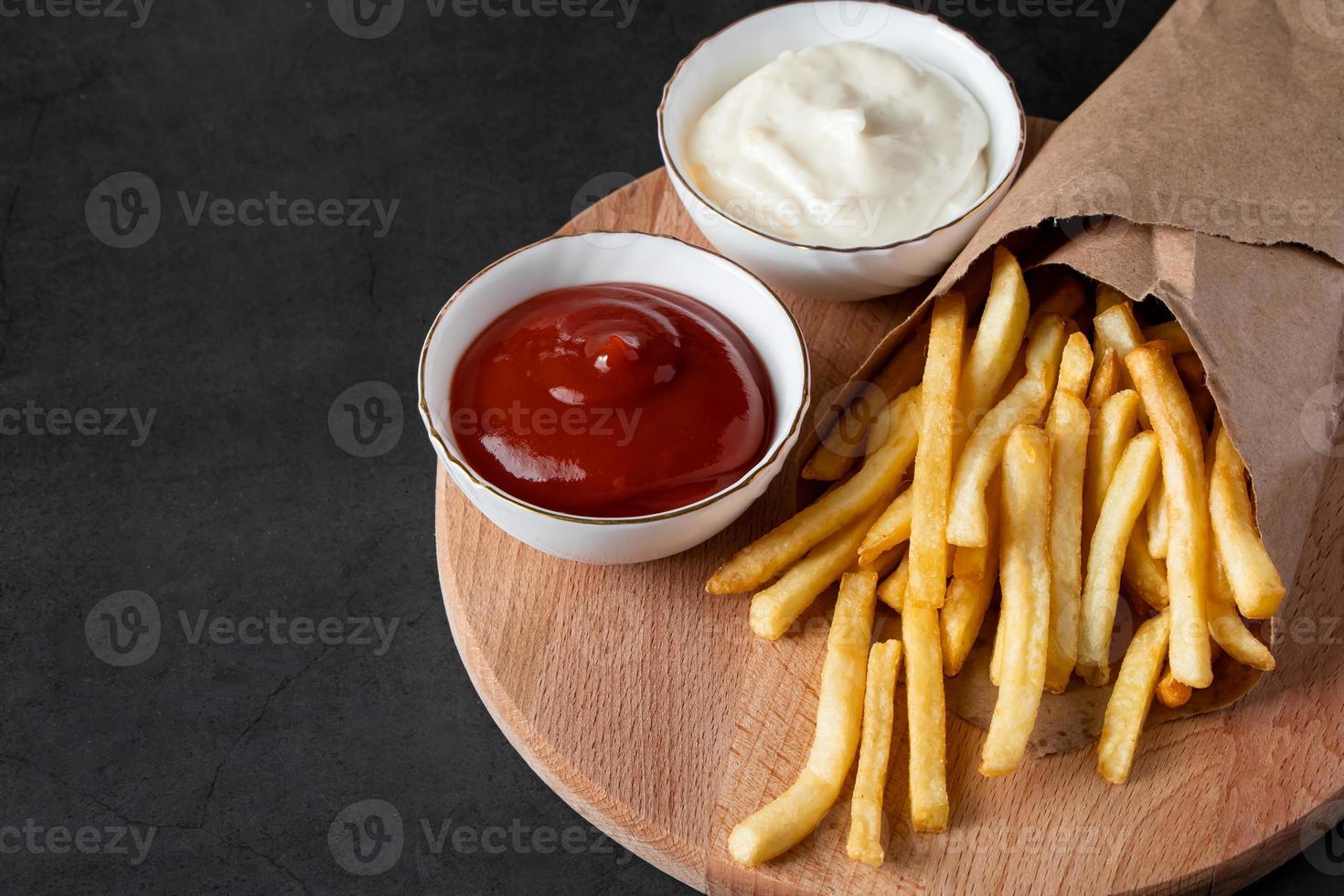 appetitose patatine fritte croccanti su sfondo nero foto