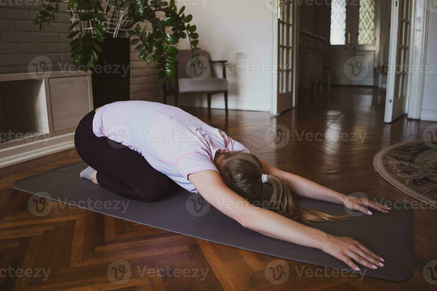 giovane donna praticante pilates e yoga esercizi a casa foto